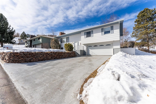 view of front of home with a garage and aphalt driveway