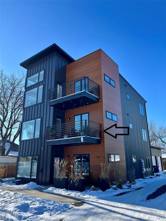 exterior space featuring a balcony and board and batten siding