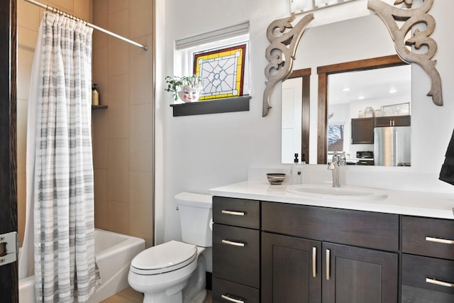 bathroom featuring toilet, shower / bath combo, and vanity