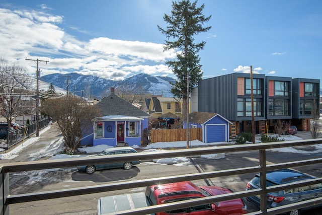 view of front of property with fence and a mountain view