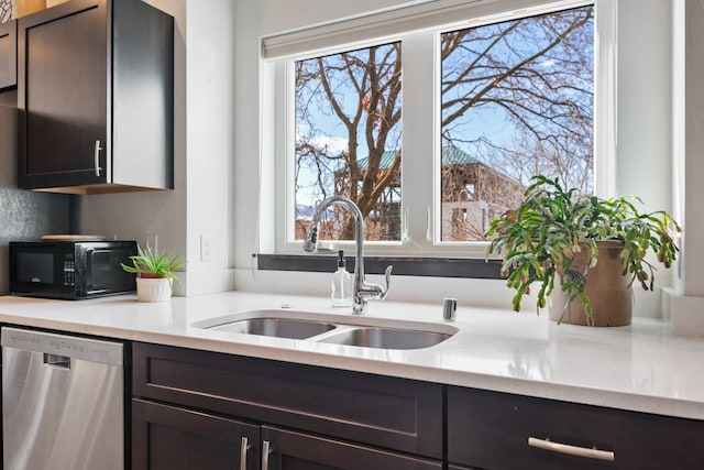 kitchen with black microwave, a healthy amount of sunlight, a sink, and stainless steel dishwasher