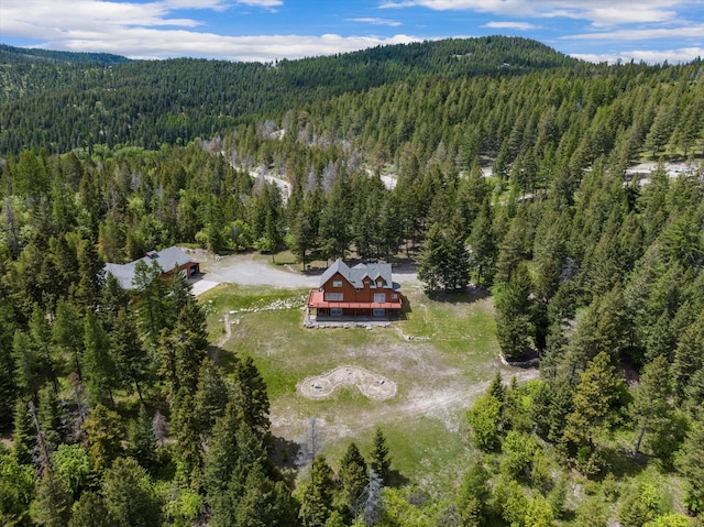 birds eye view of property featuring a view of trees