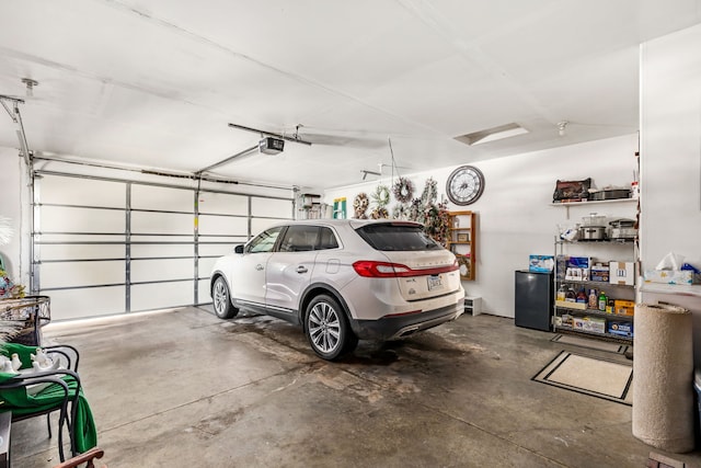 garage with refrigerator and a garage door opener