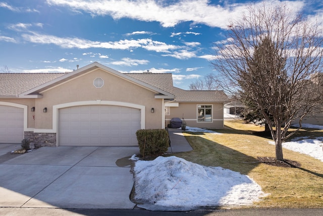 ranch-style home featuring a garage, driveway, a front lawn, and stucco siding