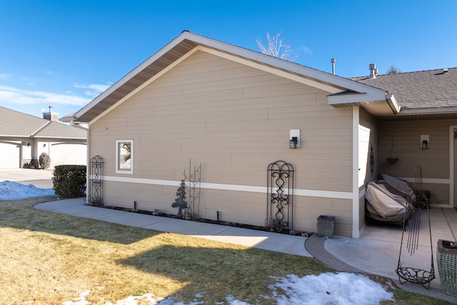 view of side of property with a yard