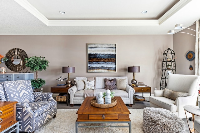 living room with a tray ceiling, crown molding, and wood finished floors