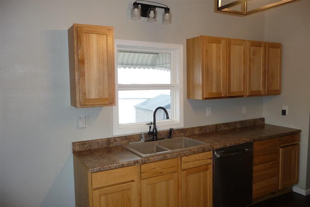 kitchen with dishwasher, dark countertops, and a sink