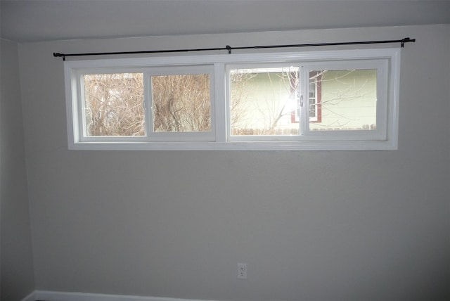 unfurnished room featuring plenty of natural light