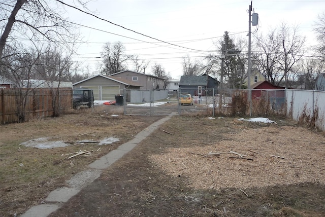 view of yard with a detached garage and fence