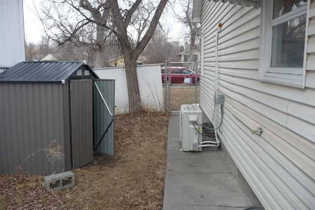 view of side of property with ac unit, fence, a storage unit, and an outdoor structure