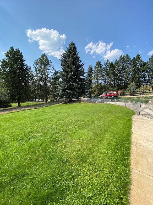 view of yard with a rural view and fence