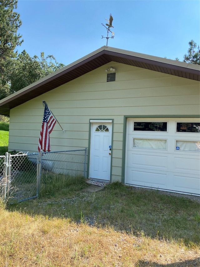 exterior space featuring a garage and fence