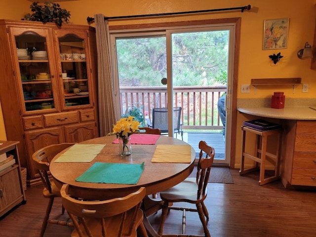 dining space with dark wood-type flooring