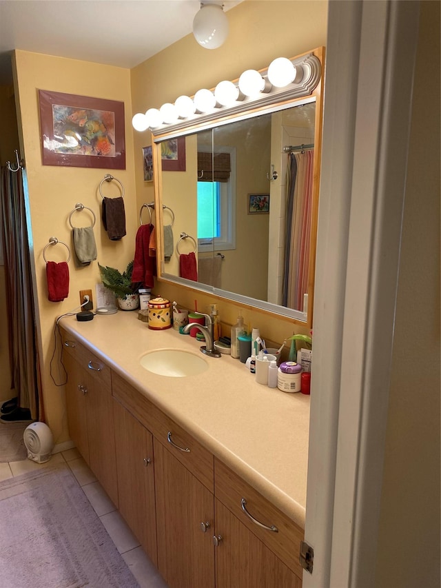 bathroom featuring tile patterned flooring and vanity