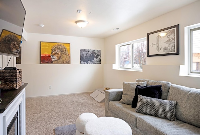 carpeted living area with visible vents and baseboards