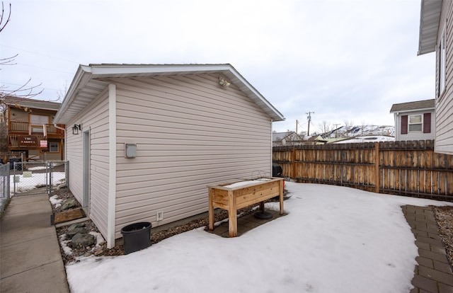 view of snowy exterior featuring fence