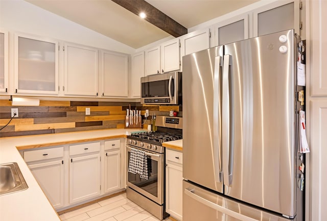 1276 River St, Missoula, MT 59801 - kitchen featuring stainless steel appliances, light countertops, glass insert cabinets, and white cabinets