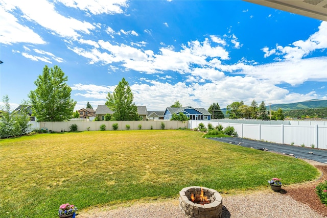 view of yard with an outdoor fire pit and a fenced backyard