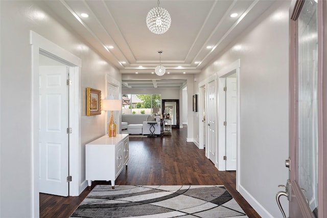 hallway with a raised ceiling, recessed lighting, dark wood finished floors, and baseboards