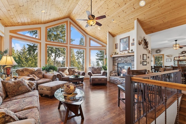 156 Wulff Ln, Lakeside, MT 59922 - living area with ceiling fan, a stone fireplace, wooden ceiling, high vaulted ceiling, and plenty of natural light