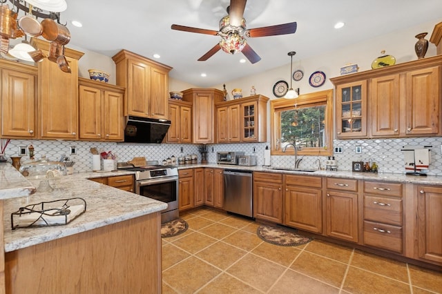 156 Wulff Ln, Lakeside, MT 59922 - kitchen with stainless steel appliances, a sink, extractor fan, a ceiling fan, and tasteful backsplash