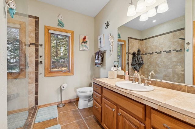 156 Wulff Ln, Lakeside, MT 59922 - bathroom with vanity, a walk in shower, toilet, tile patterned floors, and baseboards