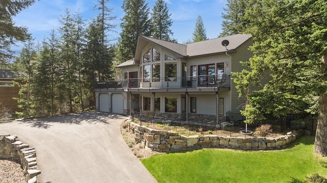 156 Wulff Ln, Lakeside, MT 59922 - view of front of home with a balcony, driveway, a front yard, and stone siding