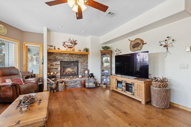 156 Wulff Ln, Lakeside, MT 59922 - living area with light wood-style flooring, ceiling fan, and a stone fireplace