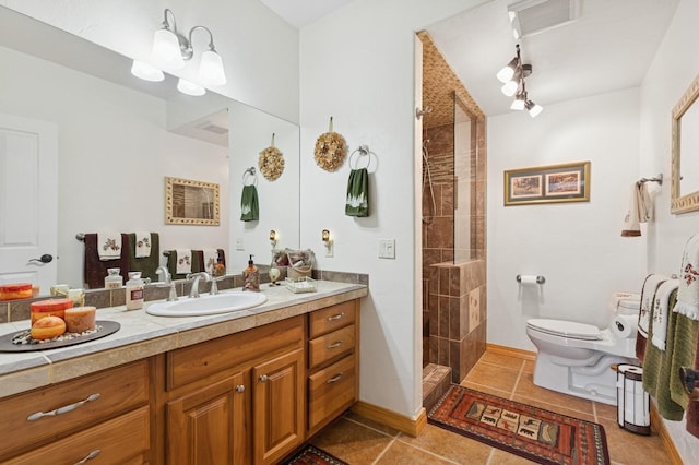 156 Wulff Ln, Lakeside, MT 59922 - bathroom with toilet, vanity, tile patterned floors, and a tile shower