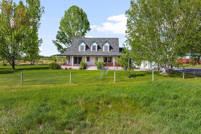 245 Olde Rd, Hamilton, MT 59840 - new england style home featuring a porch and a front lawn