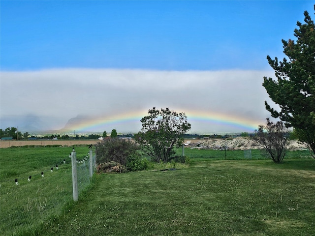 view of yard featuring a rural view and fence