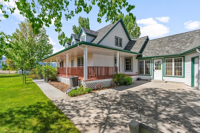 245 Olde Rd, Hamilton, MT 59840 - back of house with covered porch, a lawn, a shingled roof, and a gate
