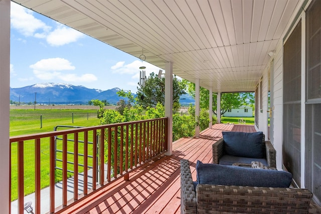 245 Olde Rd, Hamilton, MT 59840 - wooden porch with a mountain view, a lawn, and a view of rural / pastoral area