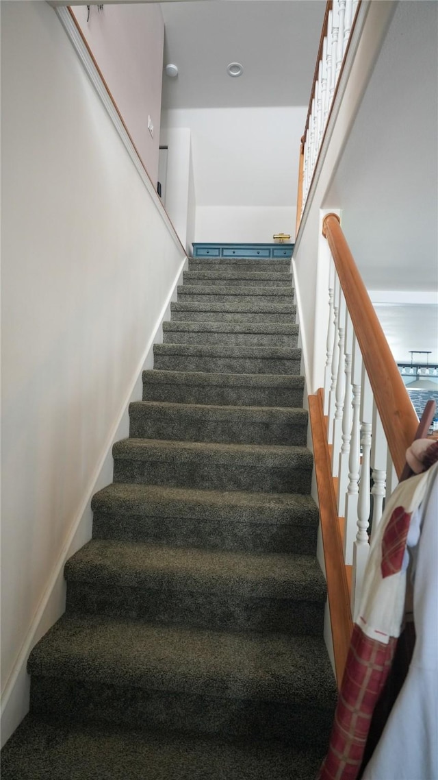 staircase featuring baseboards