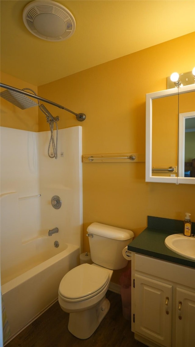 bathroom featuring shower / bathtub combination, visible vents, toilet, vanity, and wood finished floors