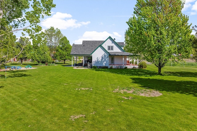245 Olde Rd, Hamilton, MT 59840 - view of front facade featuring a front lawn, covered porch, and roof with shingles