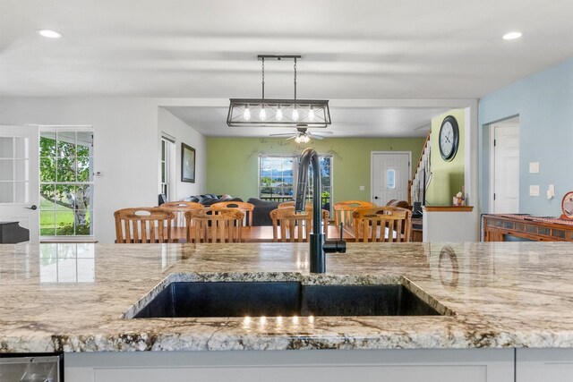 245 Olde Rd, Hamilton, MT 59840 - kitchen with a sink, a ceiling fan, light stone countertops, recessed lighting, and decorative light fixtures