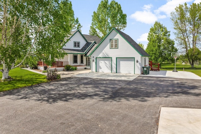 245 Olde Rd, Hamilton, MT 59840 - view of front of property with a garage, asphalt driveway, a front lawn, and roof with shingles