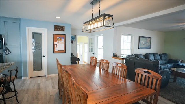 dining room with light wood-style floors, baseboards, and recessed lighting