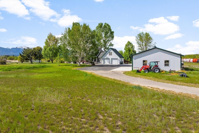 245 Olde Rd, Hamilton, MT 59840 - view of green lawn featuring an outdoor structure, a detached garage, and a mountain view