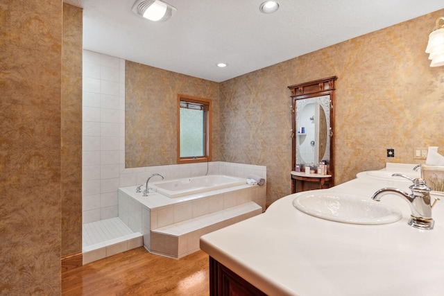 99 Golf Ter, Bigfork, MT 59911 - full bathroom featuring wood finished floors, a garden tub, and vanity