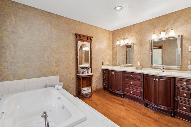99 Golf Ter, Bigfork, MT 59911 - full bathroom with a whirlpool tub, double vanity, and wood finished floors