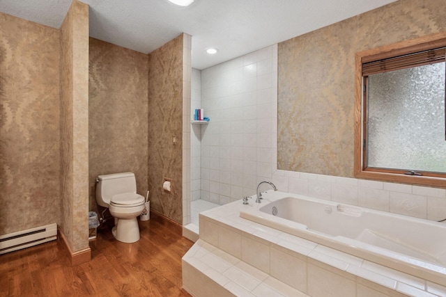 99 Golf Ter, Bigfork, MT 59911 - full bath featuring wood finished floors, baseboard heating, toilet, a bath, and walk in shower
