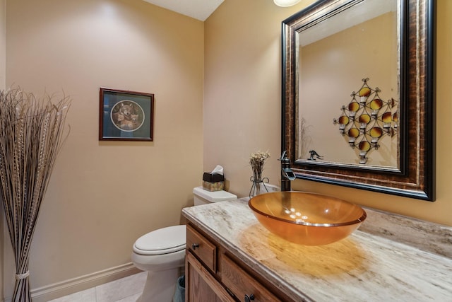 99 Golf Ter, Bigfork, MT 59911 - half bathroom featuring vanity, toilet, tile patterned floors, and baseboards