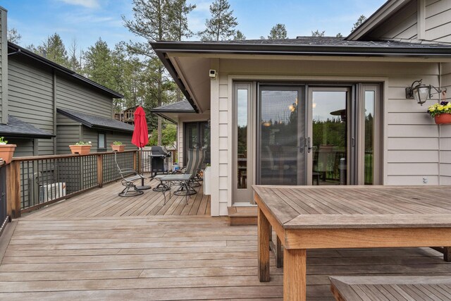 99 Golf Ter, Bigfork, MT 59911 - wooden deck featuring outdoor dining space and area for grilling