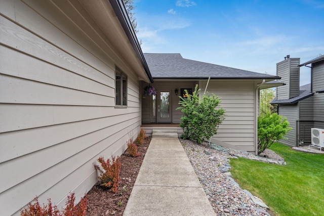 99 Golf Ter, Bigfork, MT 59911 - view of exterior entry with roof with shingles and a yard