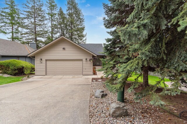 99 Golf Ter, Bigfork, MT 59911 - view of front facade with concrete driveway and a garage