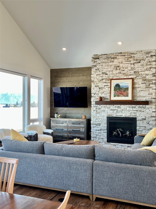 living area featuring wood finished floors, wood walls, a fireplace, high vaulted ceiling, and recessed lighting