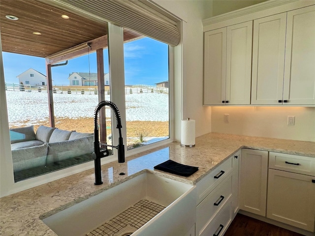 kitchen with plenty of natural light, white cabinetry, a sink, and recessed lighting