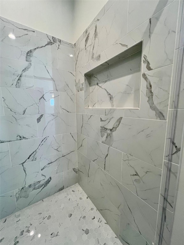 full bath with a tile shower